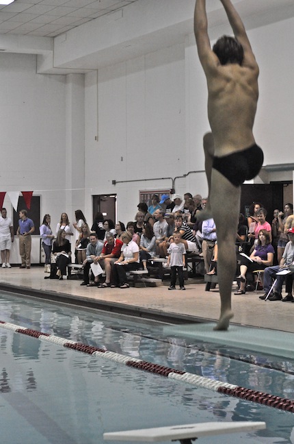 Alex Guess, junior, takes a practice dive before the meet.