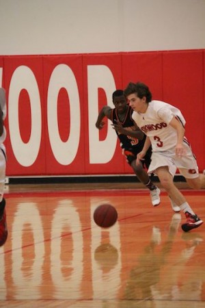 Sam Gunn, sophomore, takes the ball down the court. 