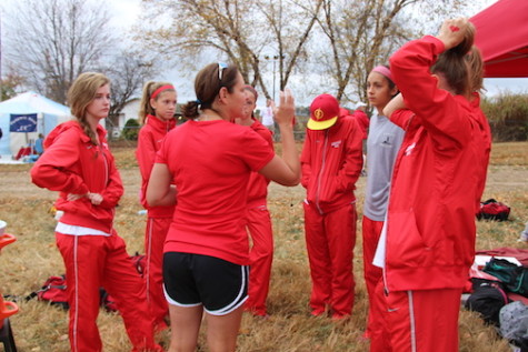 Coach Woodard gives the 7 varsity runners a motivational talk before they head to the starting line. 