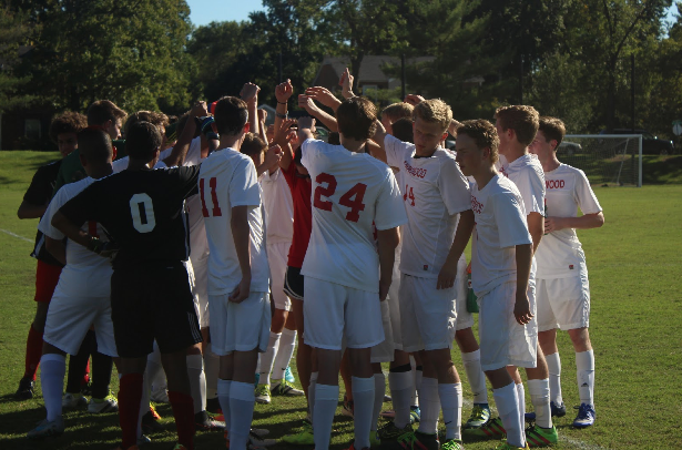 The soccer team comes together before taking the field against Northwest. 