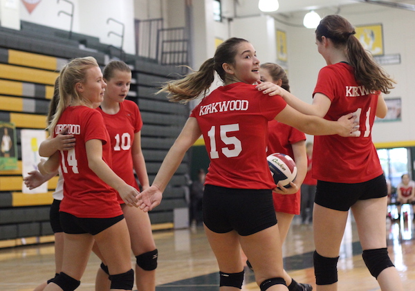 Jenna Schoch, freshman, looks back at the scoreboard as she and her teammates celebrate scoring a point.