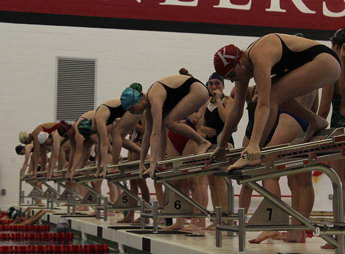 The girls’ swim and dive team members line up on the blocks at tryouts. “I’ve learned a lot from swimming,” Maddie Clark, junior, said. “I learned how to be an individual in a group because swimming is a team sport.” 