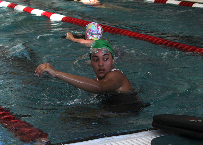 Emily Lynch, sophomore, swims laps at girls’ swim and dive tryouts. 