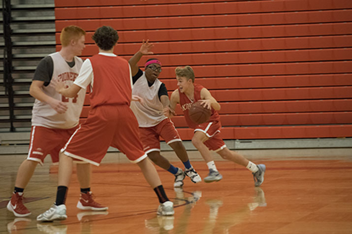 Aidan McGee, freshman, sprints down the court before making a layup.