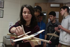 Catherine Wright, sophomore, inspects her glider before launch. Wright chose Aerospace Engineering while flipping through the course description book because she loves learning about planes. “My favorite part of the class is getting to make your own plane, instead of having to test ones that other people have made,” Wright said. “[I love that] each plane is unique.”
