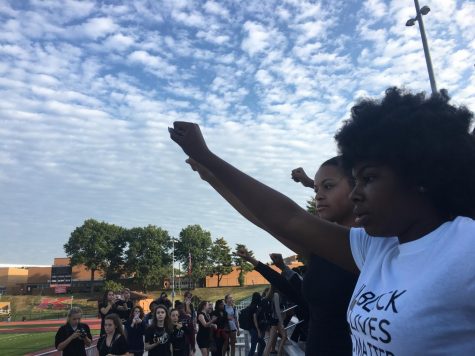Shadiya Tomlin, leader of the walkout, raises her fist in the air. The walkout is in response to the Jason Stockley verdict that rocked the St. Louis area on Friday.  