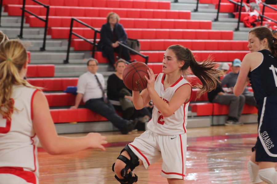 Kate Jozwiakowski, sophomore, prepares to shoot a basket. Kate always plays with a lot of heart, Jason Evans, girls JV basketball coach, said. She plays great defense and always gets to the rim and battles.