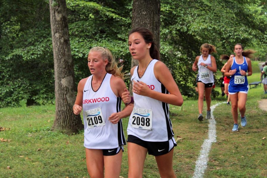 Mackenzie Scully and Kaylee Patterson, freshmen, approach the first mile marker. 