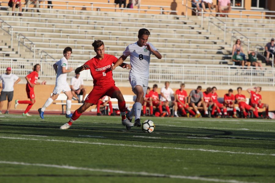 Jake Heinrichs, junior, attempts to block the opposing player and steal the ball back.