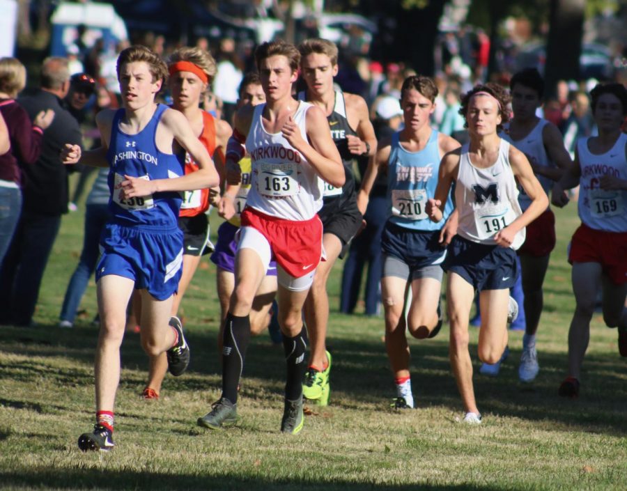 Jacob Ewen, senior, pushes past a Washington High School runner at the beginning of the race. 