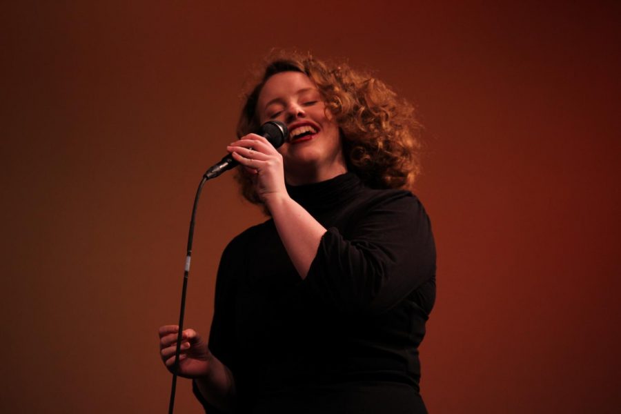 Cece Herwig, senior, holds the microphone while she hums jazz melodies.