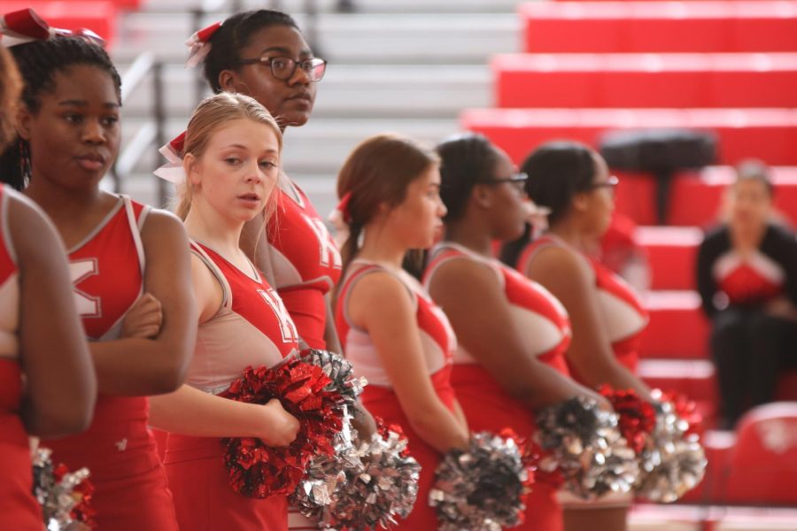 Cate Peters, sophomore, stands in line with the cheerleaders waiting for the team to be called out.