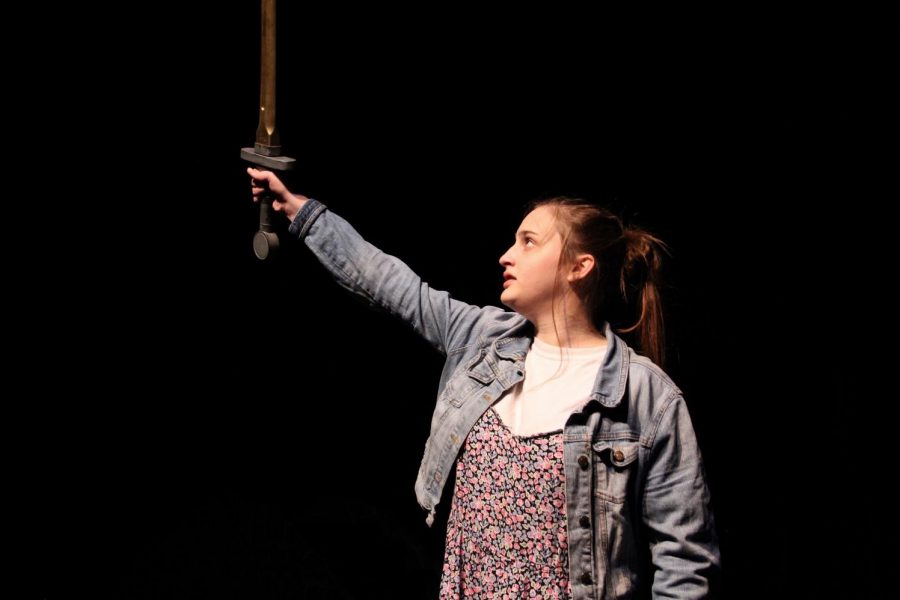 Olivia Button, sophomore, stands tall as she lifts her sword high to close out the production.