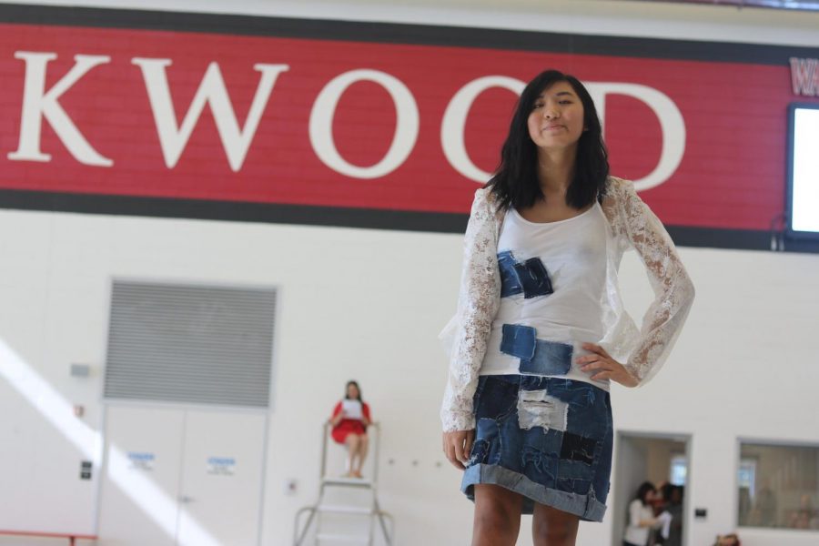 Olivia Rosenberger, sophomore, poses while smiling to the crowd sporting an up cycled denim skirt created by Sydney Malone, Alyssa Richardson, Satya Mueller, and Lindsey Tomlin.