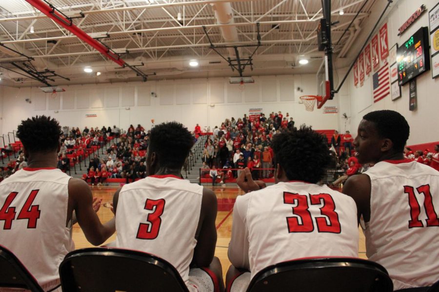 Left to right:  Maurice Massey, senior, Melvin Simmons, junior, Will Lee, sophomore, and Jaylen Phipps, sophomore, watch teammates from sideline. 