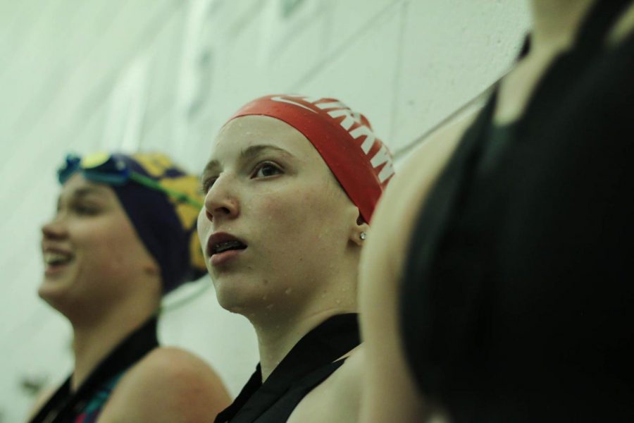 Aliya Swearngin, sophomore, stands before the crowd after placing 7th for the 50 freestyle with a time of 25:46.