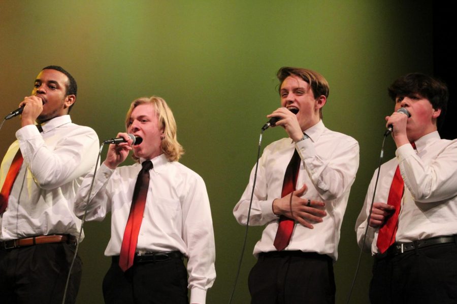 Anthony Speech and Matt Johnson, seniors, Xander Piskulic, sophomore and Mark Perry, junior, sing for the Kaleidoscope Vocal Jazz Ensemble. 