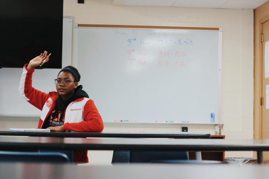 Samaya Trawick, Junior, raises her hand in math class to ask a question.