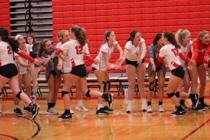 Varsity girls volleyball gets congratulated by the JV team after winning the game against Ursuline.