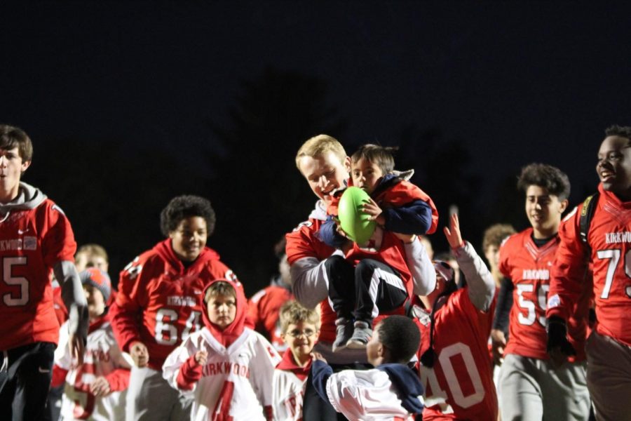 Brady Nauman, sophomore, holds Myles Young after he scored a touchdown. 