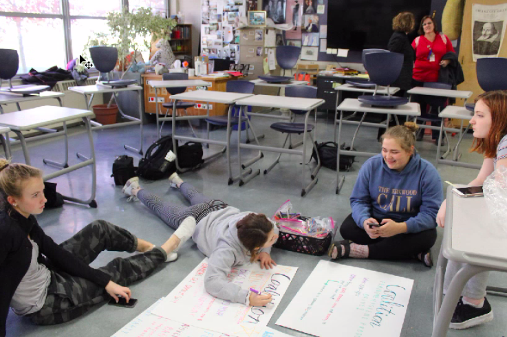 Students create posters for the upcoming feminine hygiene product drive during a Coalition Club meeting Nov. 14. 