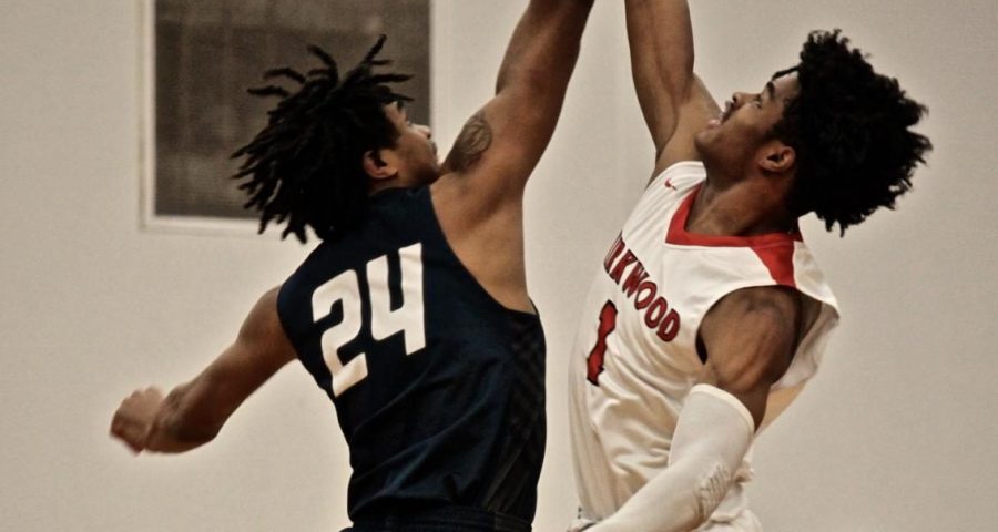 Will Lee, junior, attempts to reach pass his opponent during a jump ball.