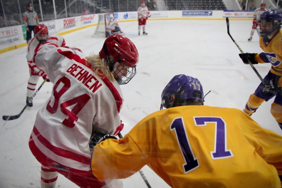 Devin Behnem, junior, fights for the puck from a CBC player.