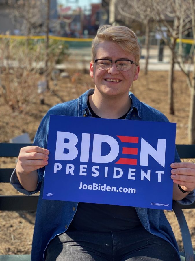 Zach Thompson sits in line with his Biden sign. 