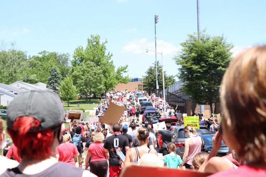 Protestors walk up Chopin street during the June 6 peace walk.