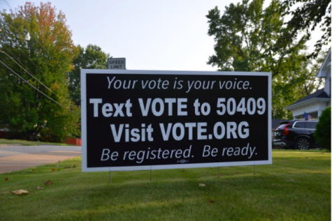 A yard sign encourages eligible voters to register and use their voice.