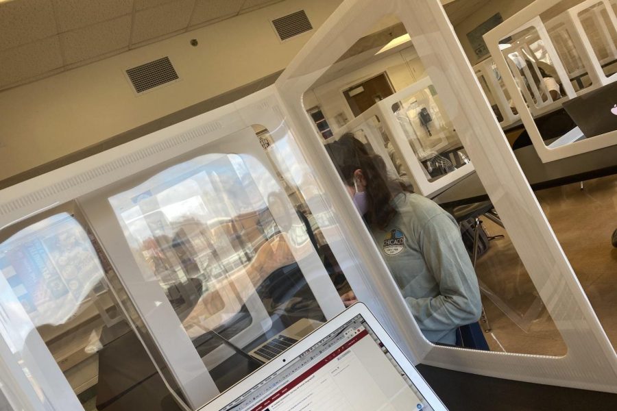 Students sit behind dividers as a precaution to stop the spread of COVID-19 amidst the return to in-person learning.