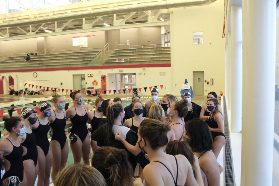 The seniors lead the rest of the team in a cheer before the meet starts. 