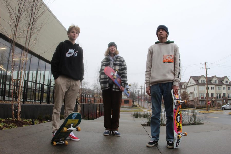 Ryder George-Lander (Left), Devon Bennett (Center) and Camden Davis (Right) standing together with their skateboards.
