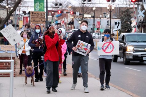 Organizers Peyton Nico and Wyatt Byers lead the front of the march as the group passes Kirkwood city hall.