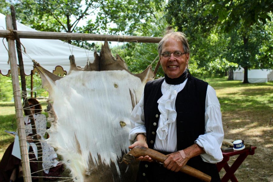 Lawrence Micheal stands in front of the deer hide he is using as an example at the folk festival.