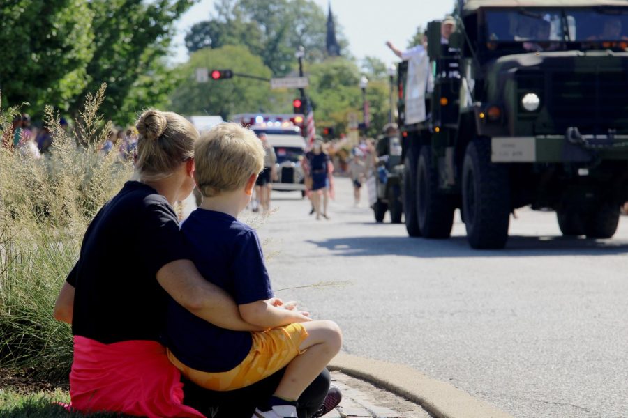 A young boy and his mom watch the parade as it comes down Argonne.