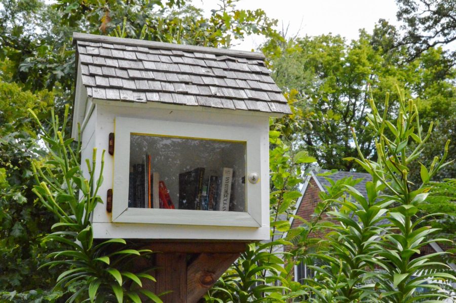 White library surrounded by greenery in a front yard of a house on N Holmes Ave.