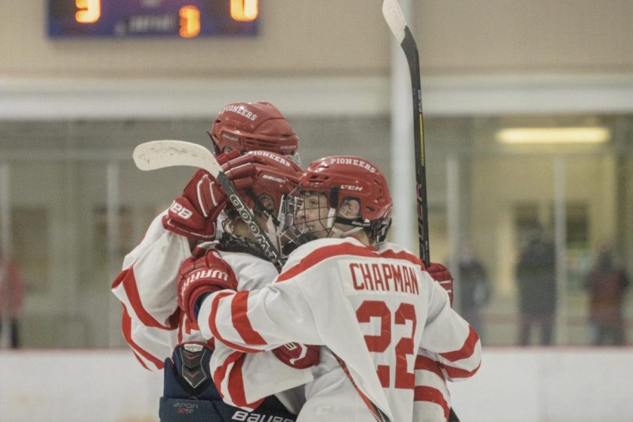 Connor Chapman, senior,  and KHS varsity hockey teammates embrace after a game. 
