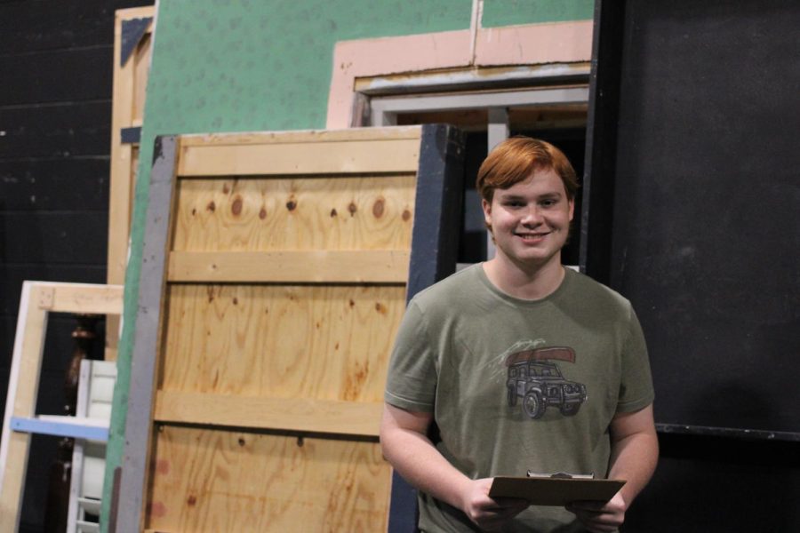 Jack Herwig stands in front of the disassembled show set with the clipboard he used during his performance.