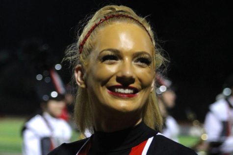 Claire Wess, senior, dances as a pommie at a  football game.