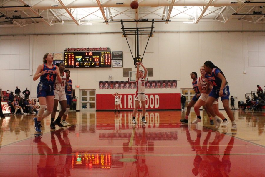 Grace Hupp, junior, shoots a free throw, while the other girls play defense against Clayton.