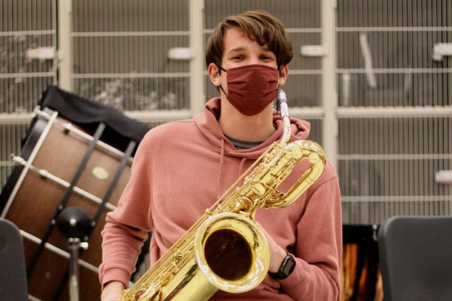 Carter Bowman holds his baritone saxophone at jazz band practice.
