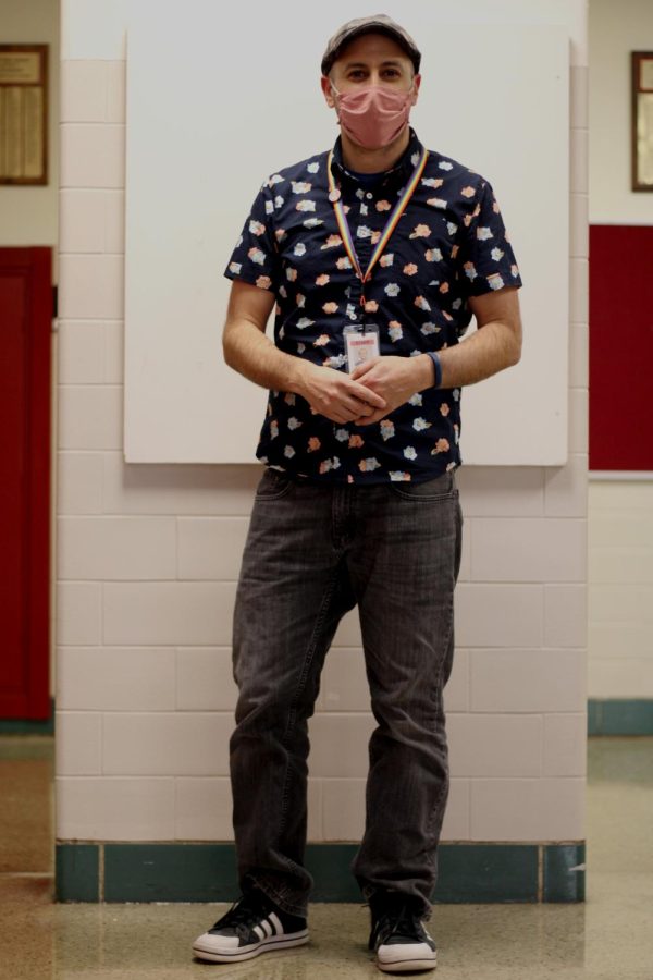 Mr. Pioter, english teacher, styling his patterned outfit. Pioter says he is drawn to clothes that are brightly colored. He also loves a good floral print.