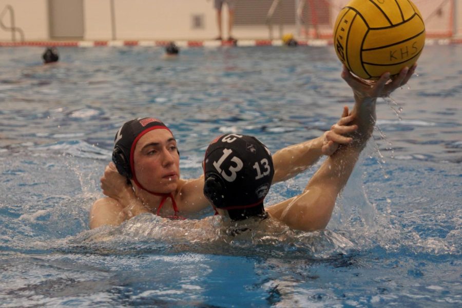 Andrew Huebner, junior, and Jackson Hardage, sophomore, practice blocking passes during practice.