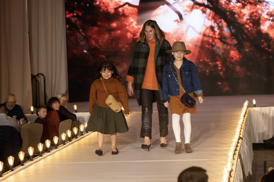 At their 2022 Fashion Show, models walk down the runway at the Ritz-Carlton.