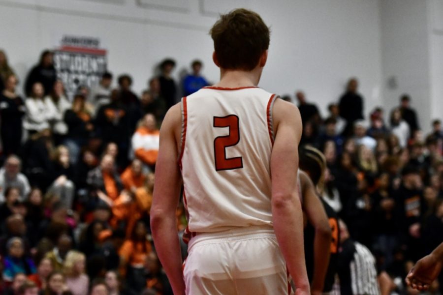 Christian Hughes, senior, standing under the basket during a pause in the game.