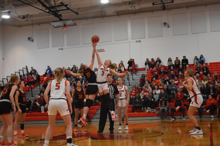 Maggie Gunn, freshman, wins the jump ball at the start of the game.