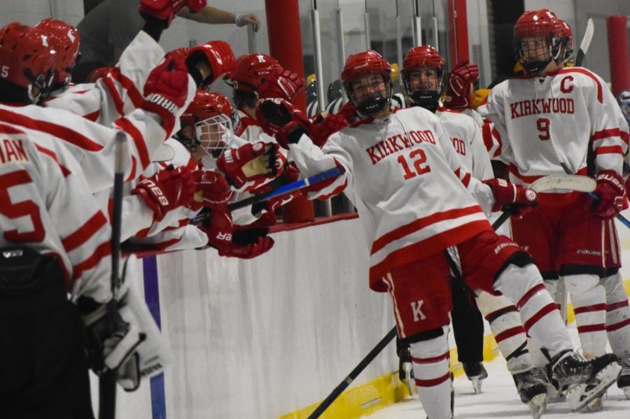 The Kirkwood team comes together to celebrate a goal, cheering loudly.
