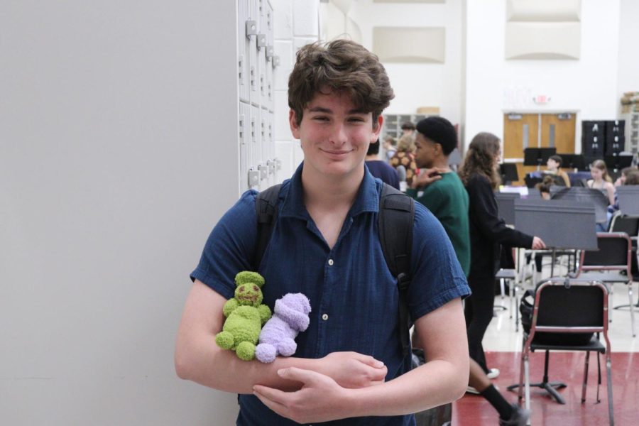 Vas Djuranovic, junior, cradles his two kids during band class. 