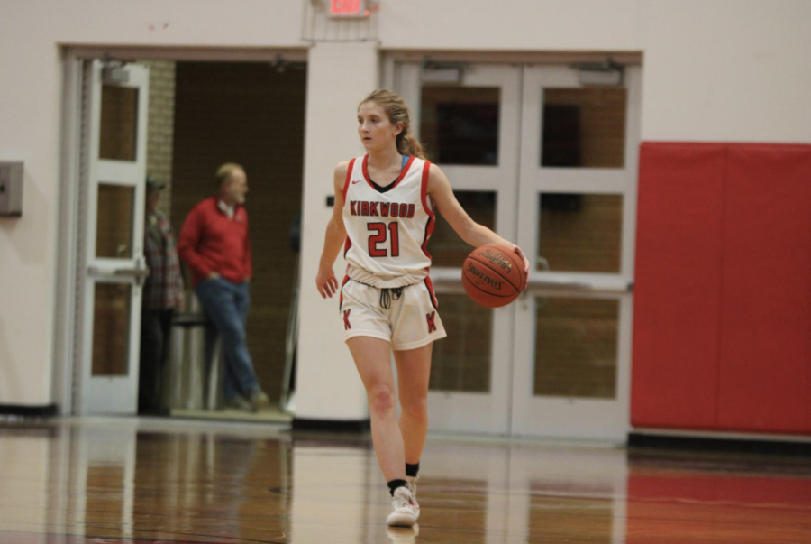 Anna Newland, junior, dribbles up the court in the David Holley Gymnasium.